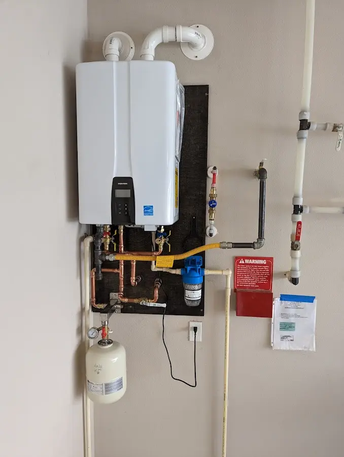 Professional plumber installing copper piping in a Eagle Point home